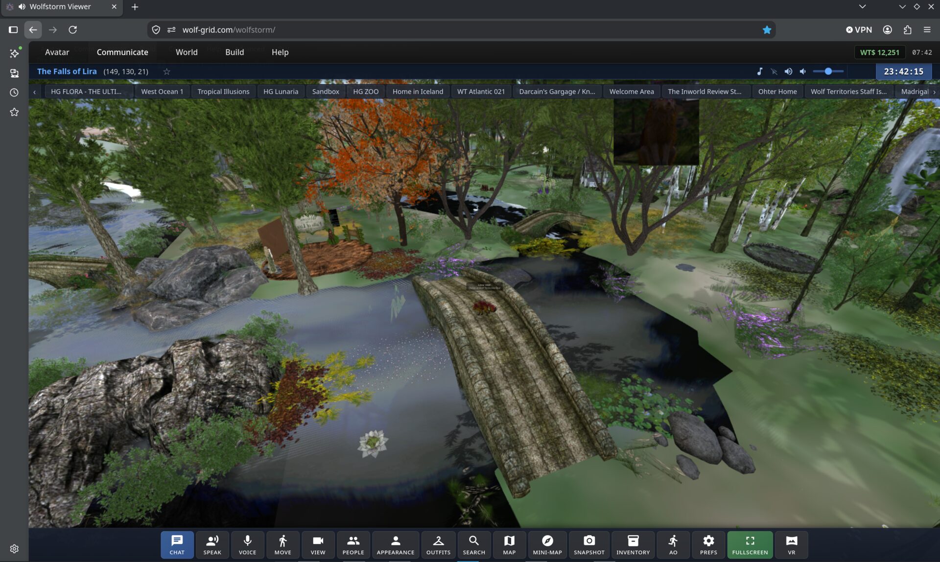 WolfStorm running in a browser tab: a wooded region with a stone bridge over a river, menus for Avatar, Communicate, World, Build and Help along the top, and a toolbar of chat, voice, movement, appearance, map, inventory, fullscreen and VR buttons along the bottom.